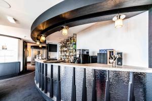 a bar in a restaurant with a counter at L'Agapa Hôtel - Spa Codage in Perros-Guirec