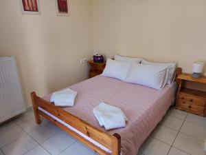 a bedroom with a bed with two towels on it at GnA Place in Zakynthos Town