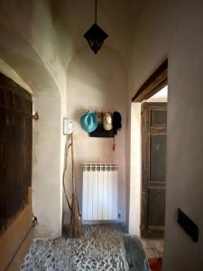 a bedroom with a bed in a room with a door at Iconic Italian Townhouse w Rooftop Terrace, Pigna in Pigna