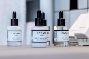 a group of four bottles of cosmetics on a counter at L'Agapa Hôtel - Spa Codage in Perros-Guirec