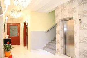 um corredor com escadas e um lustre em Palazzo Dumont Hotel em Ikuata