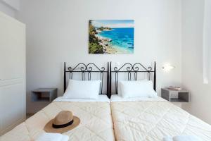 a bedroom with a bed with a hat on it at Balaris Apartments in Kassiopi