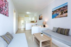 a living room with a couch and a table at Balaris Apartments in Kassiopi