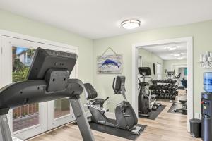 a gym with treadmills and elliptical machines at Magnolia House 504 At Destin Pointe Resort in Destin