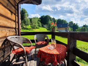 un tavolo e sedie su un portico con vista di Przytulia willa a Stryszawa