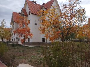 a large white house with a red roof at caprice appartement in Ifrane