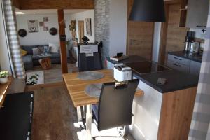 a kitchen with a table and a counter top at Ferienhaus AlpenBlick in Schöfweg +31 photos