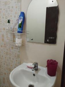 a bathroom with a white sink and a mirror at caprice appartement in Ifrane