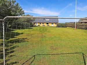 a soccer goal in a field with a building at 10 person holiday home in Vinderup in Vinderup
