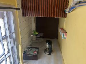 a small room with a coffee maker on a counter at A home away from home in Kolkata