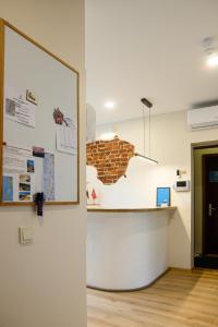 a room with a counter and a brick wall at Klaipeda Hostel in Klaipėda