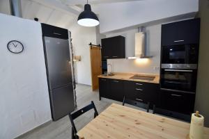 kuchnia ze stołem i zegarem na ścianie w obiekcie Casa Palmito 2 w mieście Chiclana de la Frontera +14 zdjęć