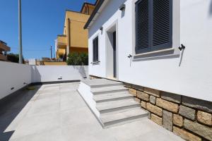a set of stairs leading up to a white building at Renovated & fully equipped-Luxurious-2Room Fontana Suite, it just doesn't get any better! in Olbia