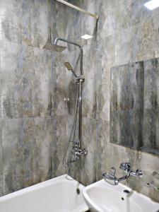 a bathroom with a sink and a tub and a mirror at SAFAR hotel in Tashkent