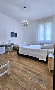 A bed or beds in a room at La Ca' Bianca Affittaly Apartments