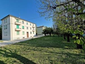 a building with a grassy yard next to a building at La Ca' Bianca Affittaly Rooms in Castenaso