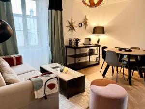 a living room with a couch and a table at Le 104 Feuvrier in Dole