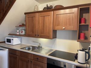 a kitchen with wooden cabinets and a sink at Phlomis in York