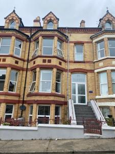 a large brick building with stairs in front of it at Ashfield Guesthouse in Douglas