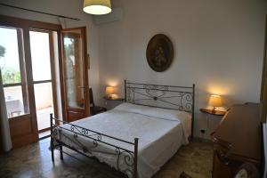 Un pat sau paturi într-o cameră la B&B Villa Dongiovanni