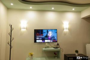a living room with a tv on the wall at Kalina Résidence in Mahajanga +7 photos