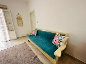 a living room with a blue couch with pillows on it at Your perfect escape in Emporios! in Kalymnos
