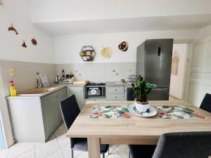 a kitchen with a wooden table and a refrigerator at Your perfect escape in Emporios! in Kalymnos