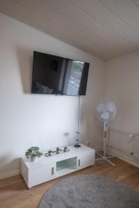 a living room with a flat screen tv on the wall at Araucarias apartment in Kotka