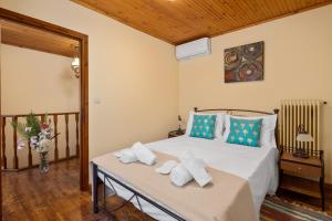 a bedroom with a bed with towels on a table at Lemon Tree House in Kouramádes