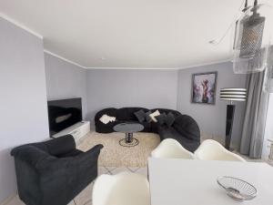 Sala de estar con 2 sofás y mesa en Ruhiges Juwel: frisch renoviert 100 qm, en Julich