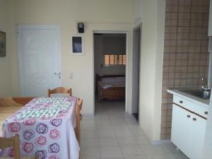 a kitchen with a table with a table cloth on it at Armenistis apartment in Armenistis