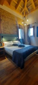 a bedroom with a large bed with a blue blanket at Corte Lusenzo in Chioggia