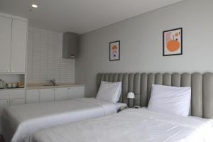 Postel nebo postele na pokoji v ubytování Hotel Seogwipean