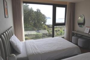 Postel nebo postele na pokoji v ubytování Hotel Seogwipean