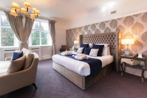 a bedroom with a large bed and a couch at The Mount Country Manor Hotel & Golf Wolverhampton in Wolverhampton