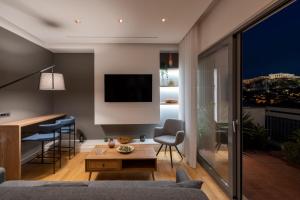 a living room with a couch and a table at Acropolis Luxury Penthouses with Majestic Views in Athens
