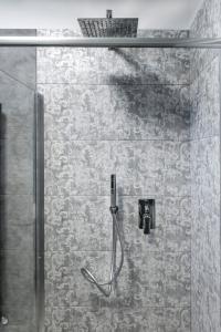 a shower in a bathroom with a shower at PETIT AFFITTACAMERE in Loreto