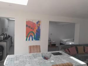 a living room with a table and a couch at One bed stunning apartment with parking right outside, close to Burton town centre in Burton upon Trent