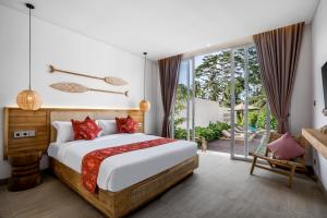 a bedroom with a large bed and a balcony at Villa Sunrise by BaliSuperHost in Ubud