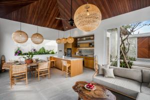a living room with a couch and a table at Villa Sunrise by BaliSuperHost in Ubud