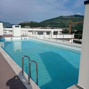 a large blue swimming pool on top of a building at Apartman Mango & Mia in Trebinje
