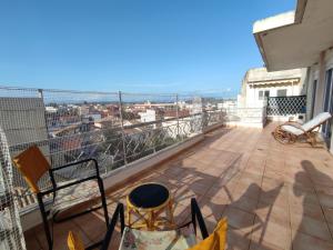 a balcony with chairs and a view of a city at Penthouse View in Preveza