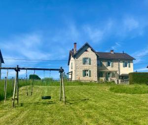 an empty playground in front of a house at La petite marmite du lac de Vouglans in Pont-de-Poitte