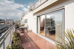 an apartment balcony with a view of the city at Acropolis Luxury Penthouses with Majestic Views in Athens