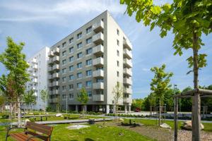 a building with a park in front of it at Urban & Green Apartments by Ambiente in Prievoz