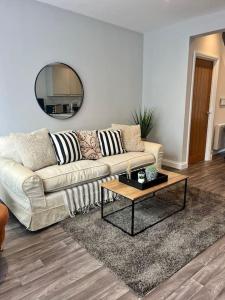 a living room with a couch and a table at Surrey Street Duplex in Norwich