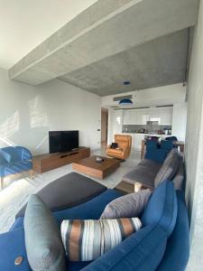 a living room with a blue couch and a tv at Simpaş Queen residence 2 bedroom in Istanbul