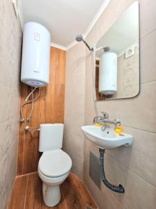 a bathroom with a toilet and a sink at Yellow studio in Varna City