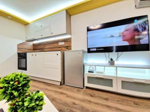 a kitchen with a large flat screen tv on the wall at Yellow studio in Varna City