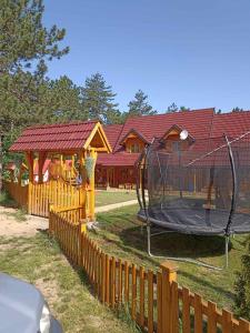 a playground with a trampoline in front of a house at Vila Perisic in Kaludjerske Bare